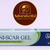 Uni-Scar Gel 20gm tube and box on white table with Adorabella logo and green natural background
